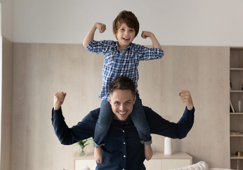 Cheerful,Little,Boy,Riding,On,Happy,Dads,Neck,And,Shoulders,